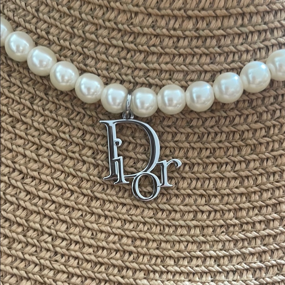 Authentic Dior Charm in exquisite pearl necklace.